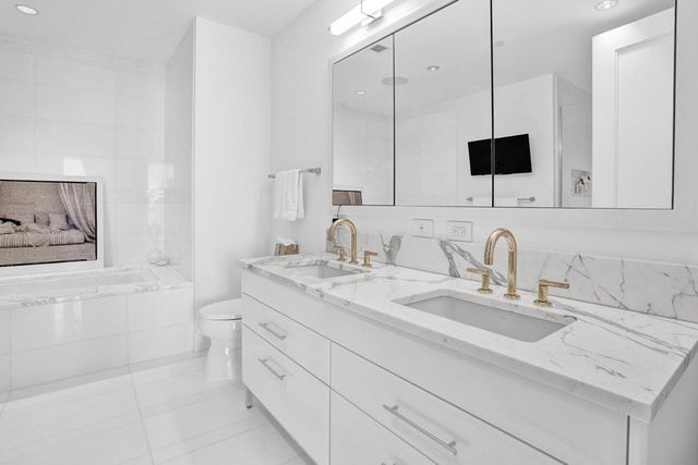 a bathroom with a sink double vanity and a mirror