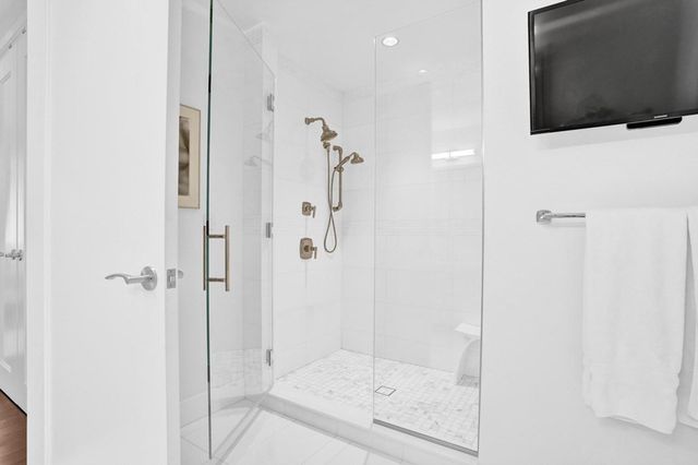 a bathroom with a shower and a sink