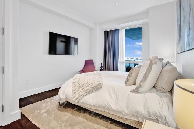 a bedroom with a bed and a night stand