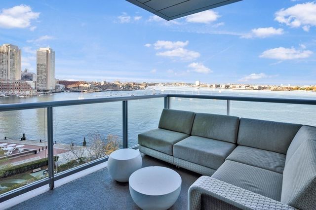 a view of roof with furniture and city view