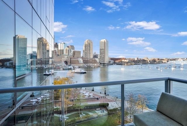 a view of swimming pool with outdoor seating and city view