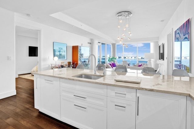 a kitchen with white cabinets and a sink