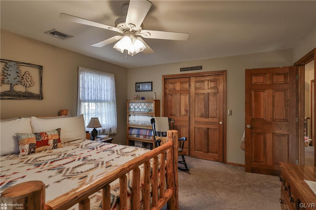 193 Nolf Road Nazareth, PA 18064 - Photo 38 of 47 a bedroom with a bed and a chandelier