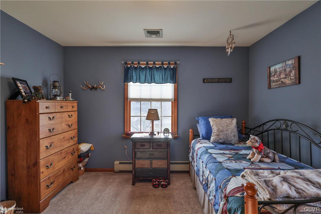 193 Nolf Road Nazareth, PA 18064 - Photo 40 of 47 a bedroom with a bed and wooden floor
