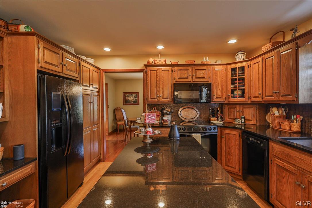 193 Nolf Road Nazareth, PA 18064 - Photo 6 of 47 a kitchen with stainless steel appliances granite countertop a refrigerator a stove and a sink with wooden cabinets