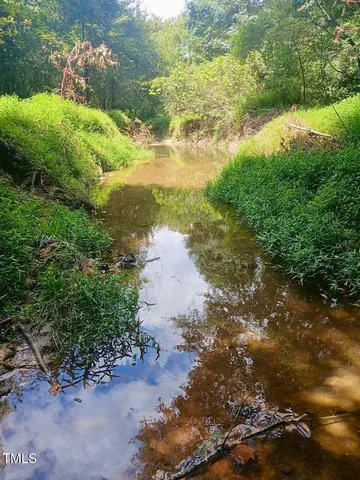 a view of a lake with beach and outdoor space