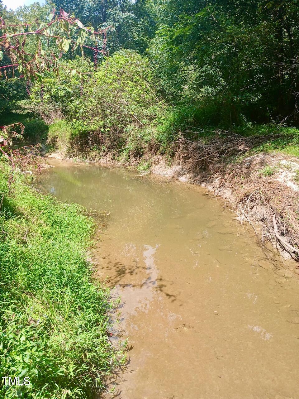 708 Tollie Weldon Road Henderson, NC 27537 - Photo 15 of 31 a view of a lake with beach and outdoor space