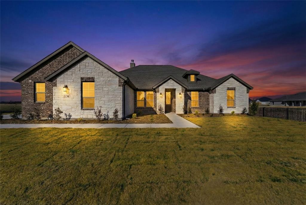 138 Snowy Owl Trail Rhome, TX 76078 - Photo 1 of 1 a front view of a house with yard and green space