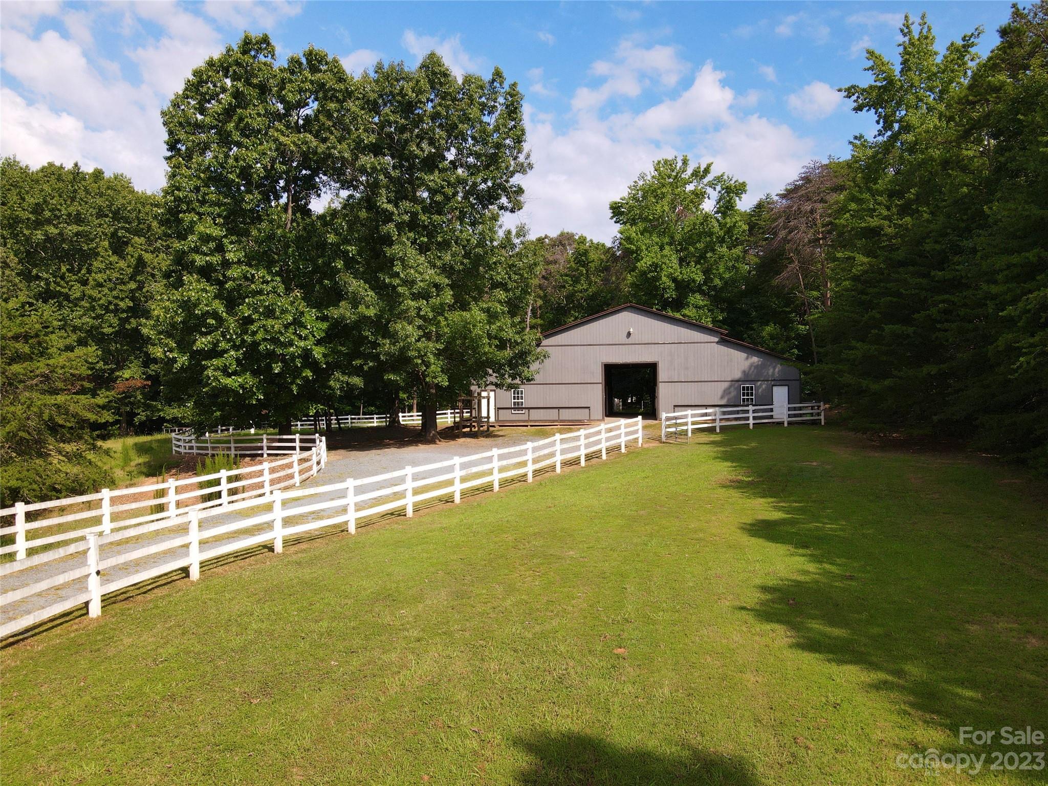 a house view with swimming pool in front of it