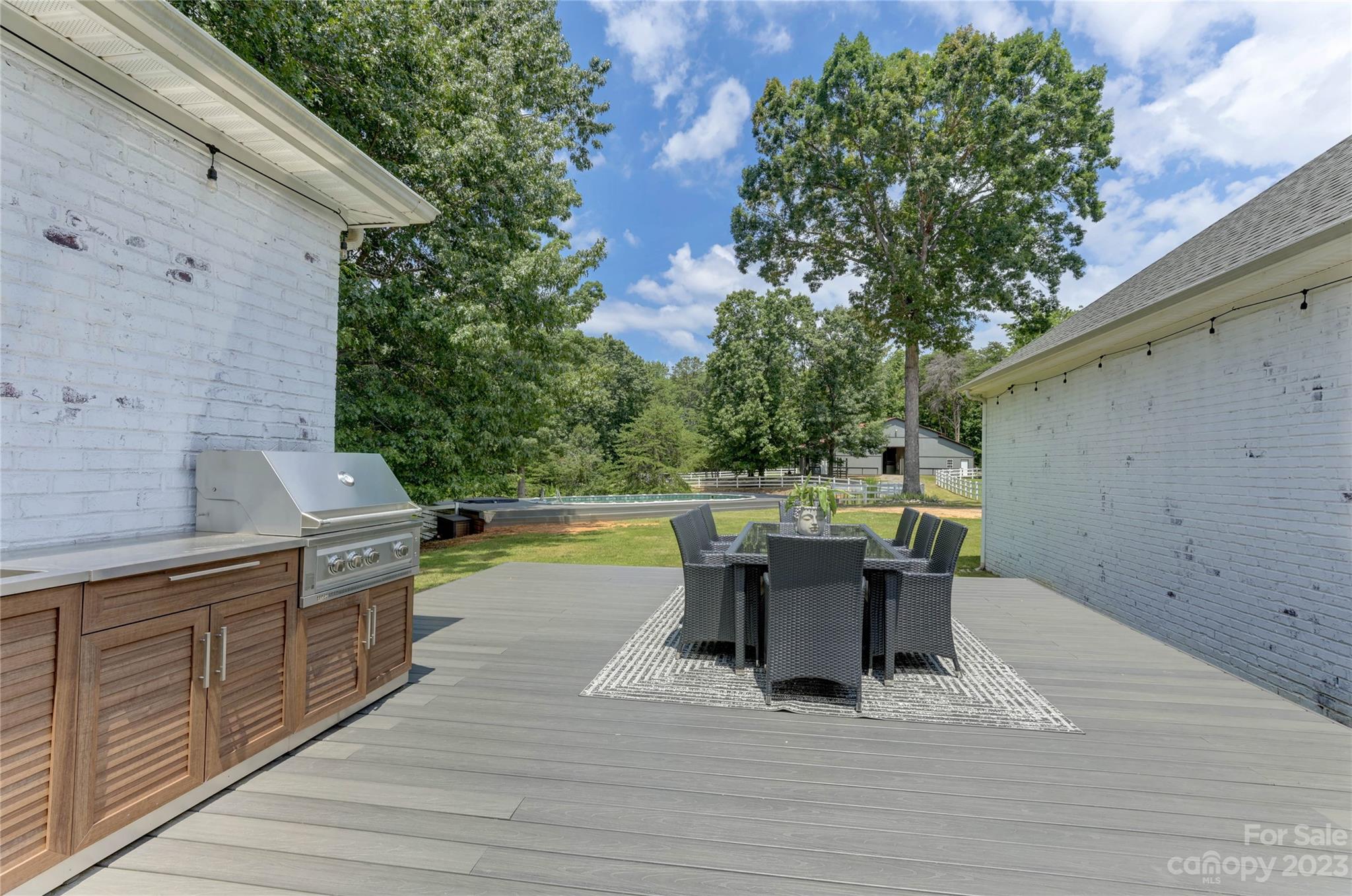 2354 Vineyard Road Fort Mill, SC 29708 - Photo 47 of 48 a view of a patio with table and chairs and wooden floor