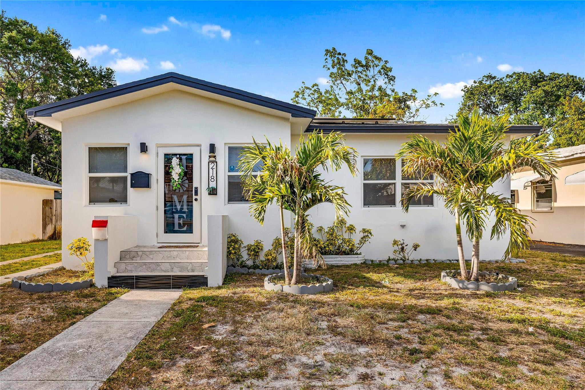 218 Southwest 7th Street Dania Beach, FL 33004 - Photo 3 of 57 a front view of a house with a porch