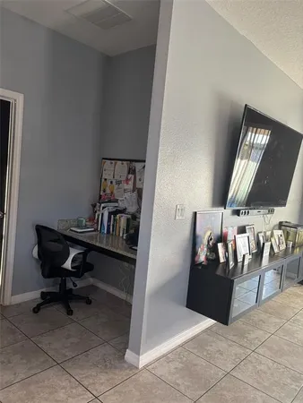 a living room with couches a fireplace and a dining table with a large window