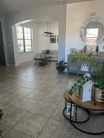 a living room with furniture and a ceiling fan