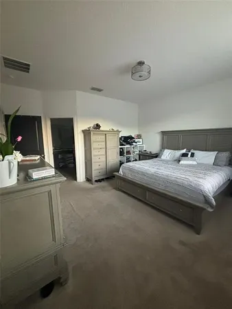 a bedroom with bed and window