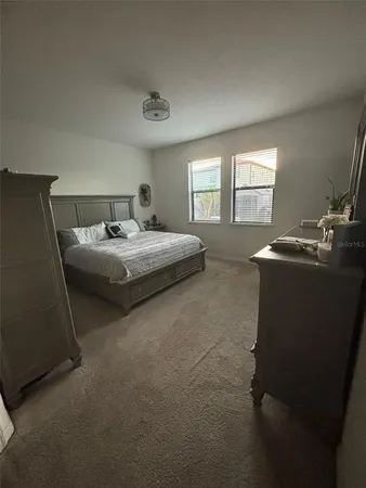 a bedroom with bed and window