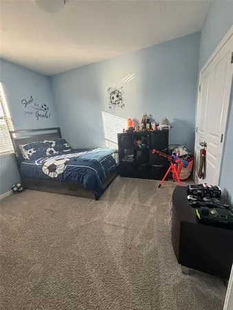a bedroom with a bed and window