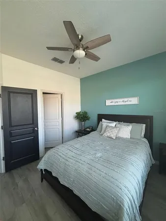 a bedroom with a bed and a window