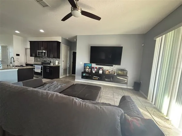 a kitchen with stainless steel appliances granite countertop a sink refrigerator and cabinets
