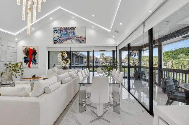 a living room with furniture and a floor to ceiling window