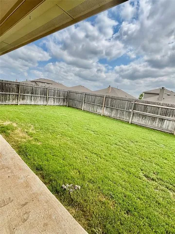 a view of a big yard with potted plants