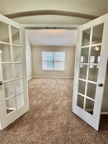 a view of an empty room with a window