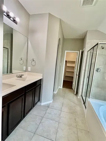 a bathroom with a sink a toilet and a large mirror