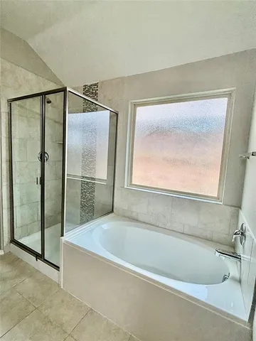 a bathroom with a bathtub and a shower