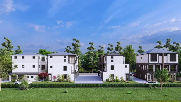 an aerial view of a house with garden space and a street view