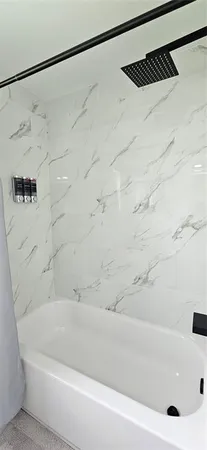 a bathroom with a shower and a bathtub