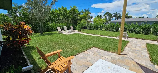a view of a backyard with sitting area