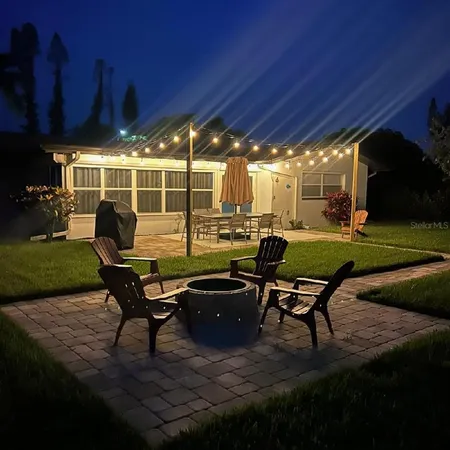 a view of a backyard with garden and sitting area