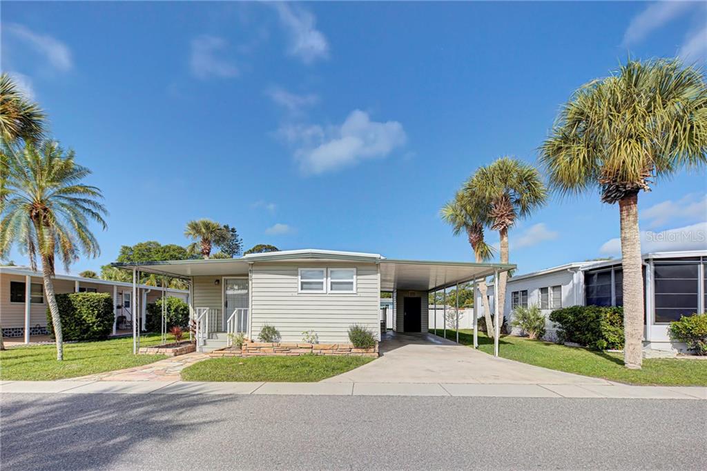 6150 Teahouse Road Venice, FL 34293 - Photo 1 of 1 a front view of a house with a yard and garage