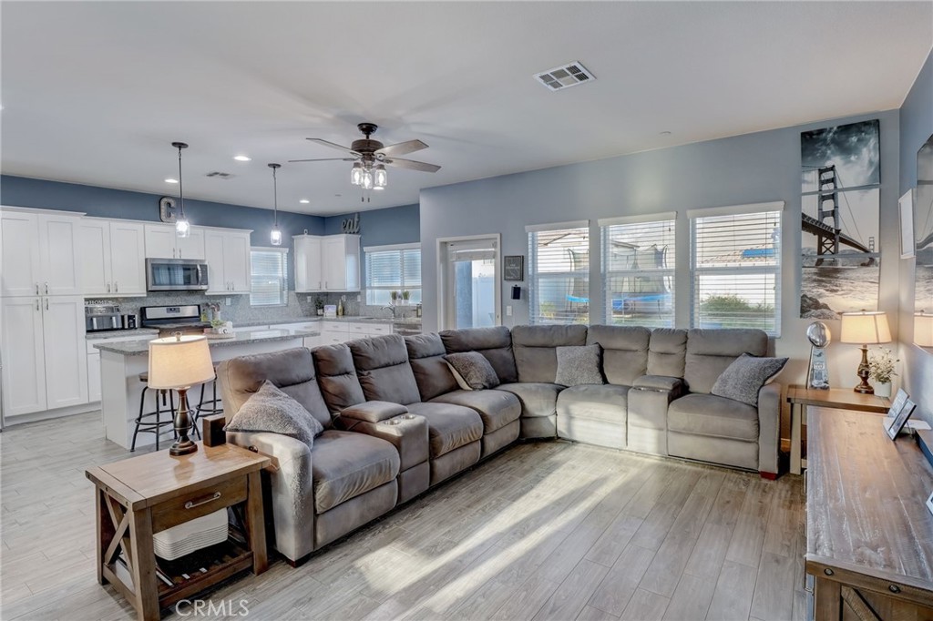 1667 Constant Trail San Jacinto, CA 92582 - Photo 15 of 44 a living room with furniture and kitchen view