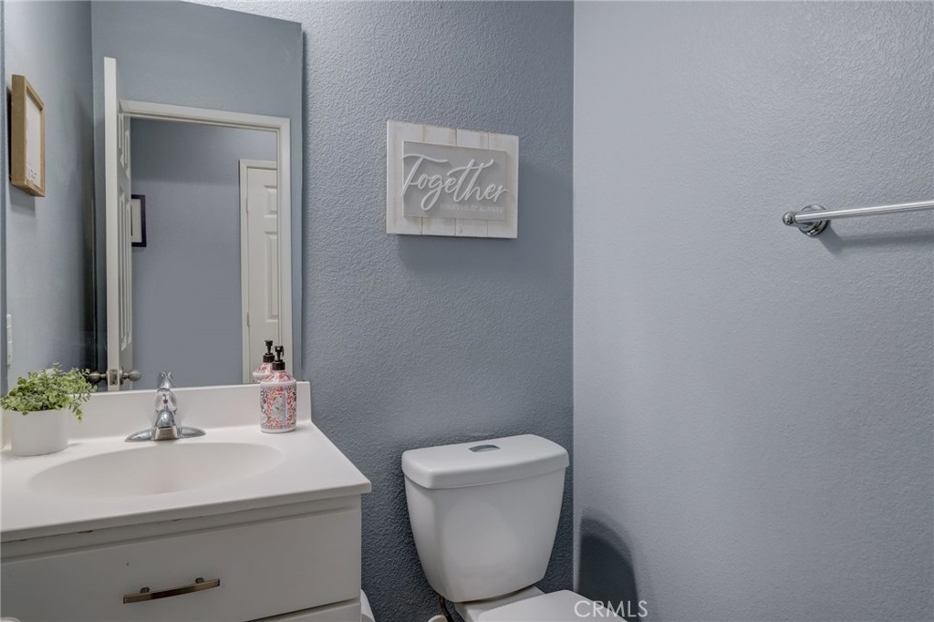 1667 Constant Trail San Jacinto, CA 92582 - Photo 16 of 44 a bathroom with a toilet sink and mirror