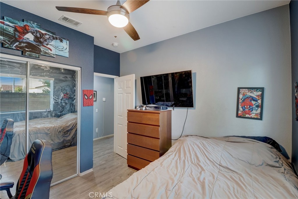 1667 Constant Trail San Jacinto, CA 92582 - Photo 22 of 44 a bedroom with a bed and a flat screen tv