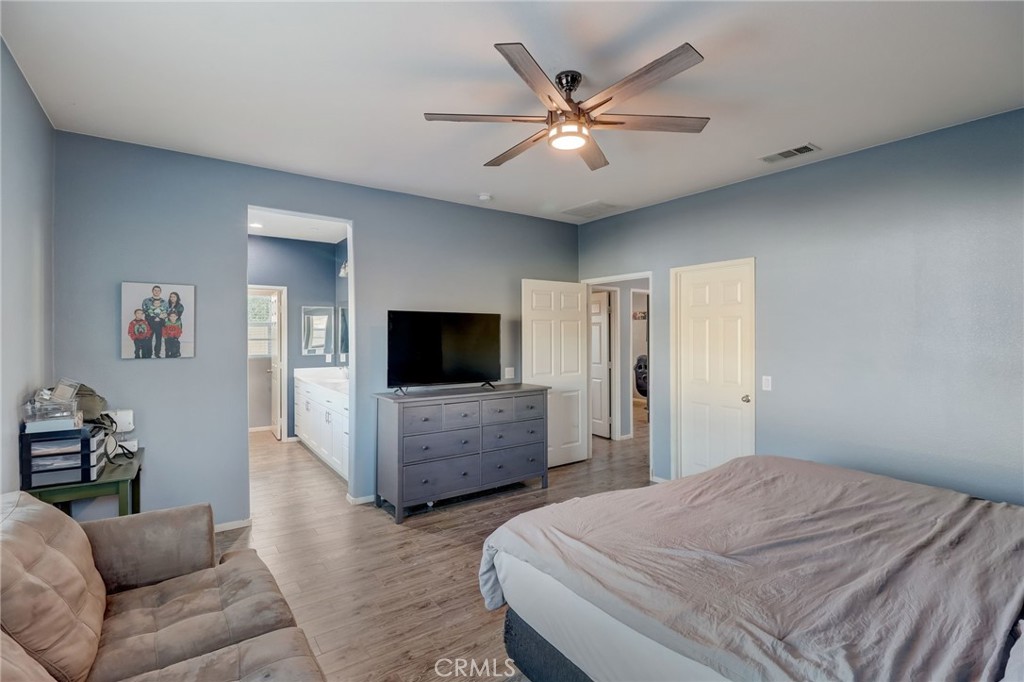 1667 Constant Trail San Jacinto, CA 92582 - Photo 26 of 44 a bedroom with a bed and a flat screen tv