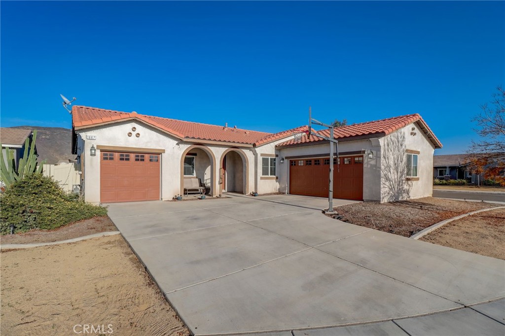 1667 Constant Trail San Jacinto, CA 92582 - Photo 5 of 44 a front view of a house with a yard and garage