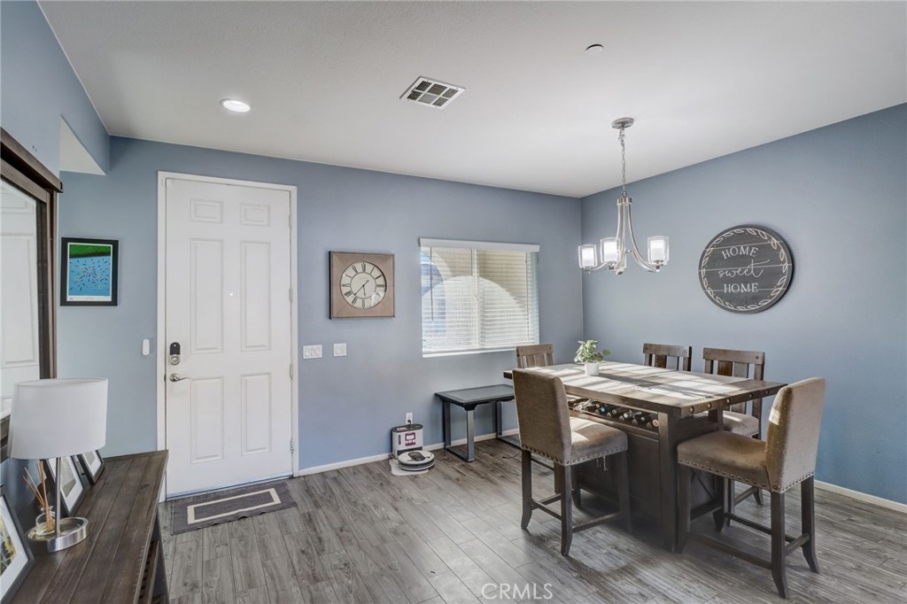 1667 Constant Trail San Jacinto, CA 92582 - Photo 6 of 44 a view of a dining room with furniture and a chandelier