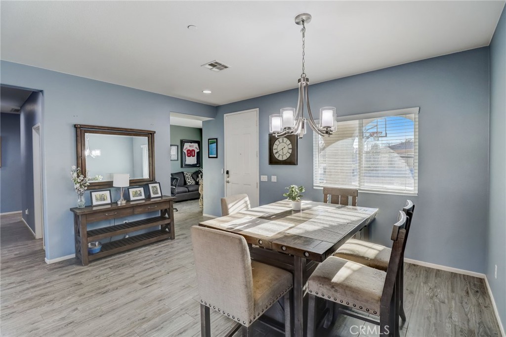 1667 Constant Trail San Jacinto, CA 92582 - Photo 7 of 44 a view of a dining room with furniture window and wooden floor