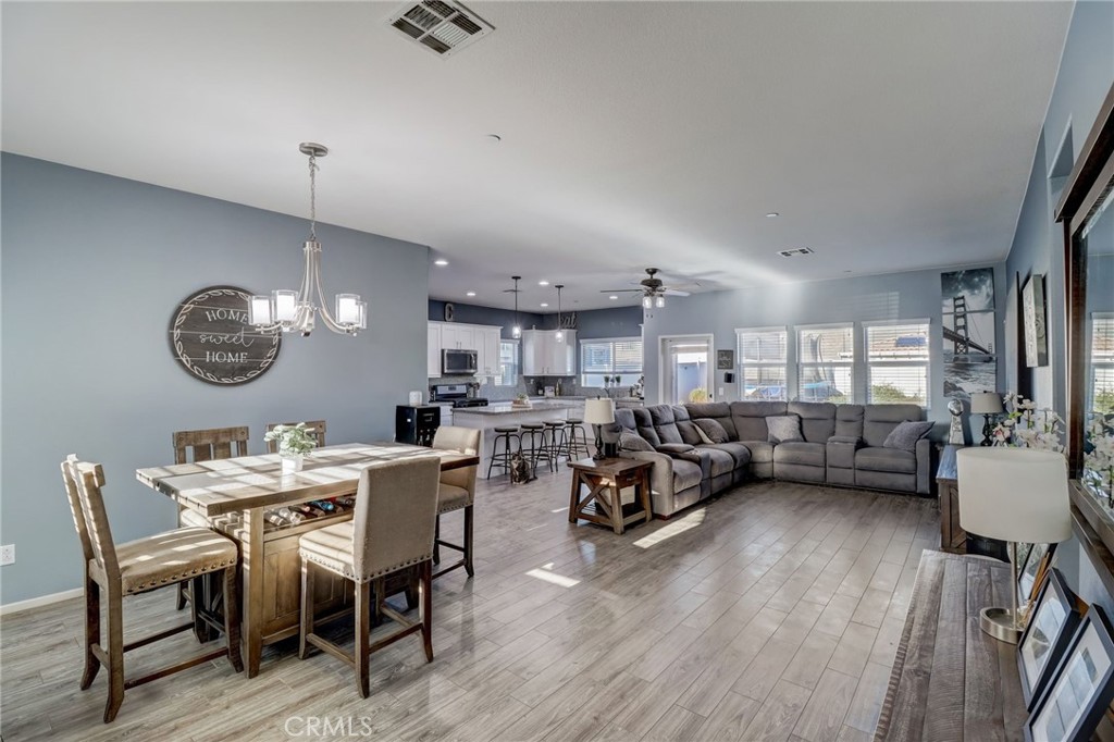 1667 Constant Trail San Jacinto, CA 92582 - Photo 8 of 44 a view of a dining room with furniture window and wooden floor