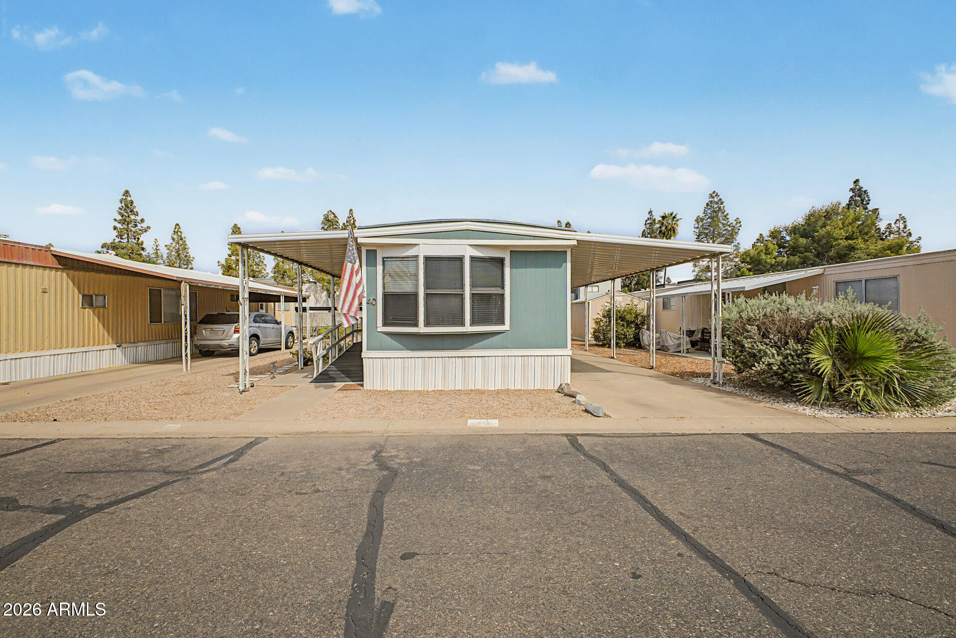 535 South Alma School Road, Unit 40 Mesa, AZ 85210 - Photo 1 of 33 a patio with a table and chairs and potted plants