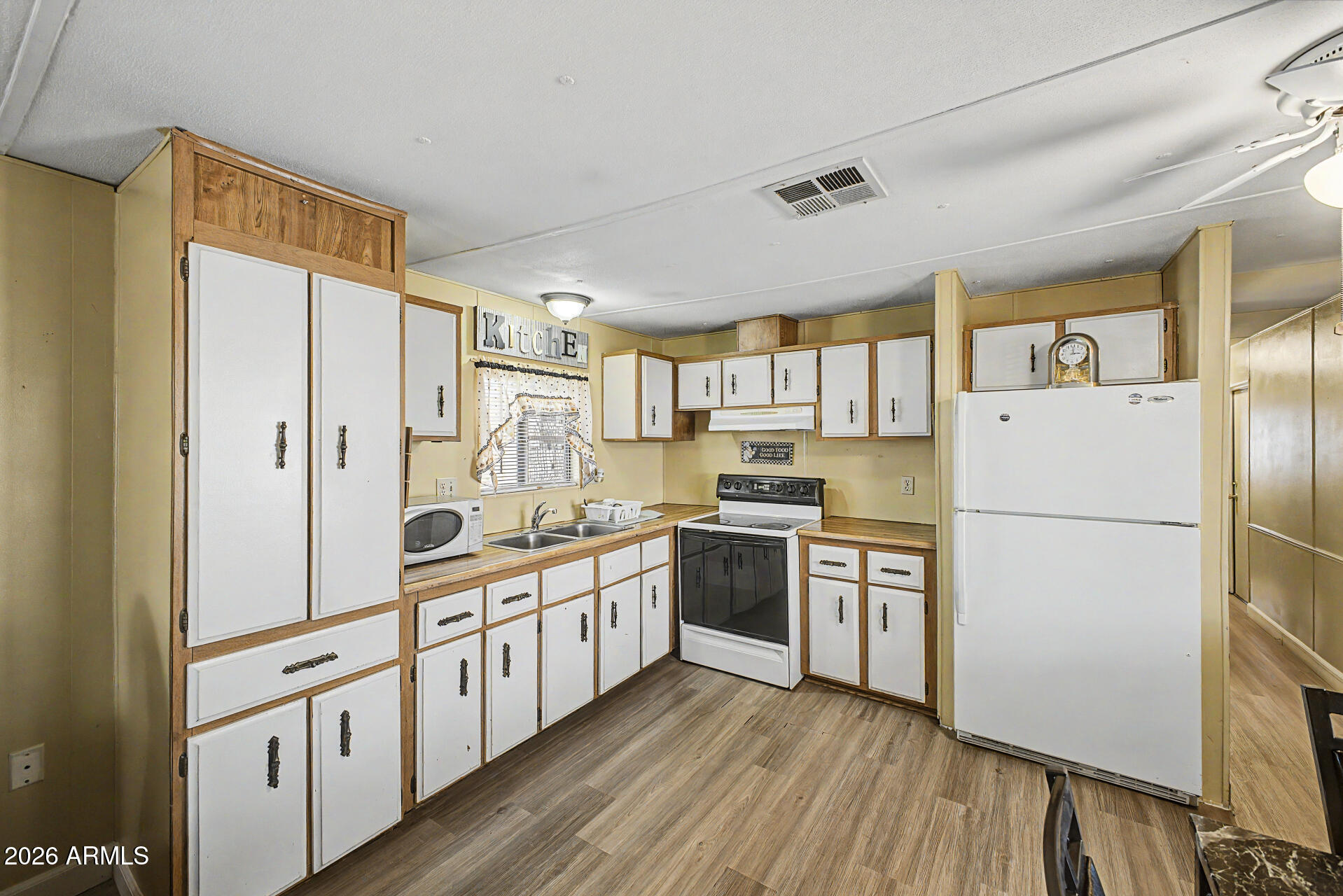 535 South Alma School Road, Unit 40 Mesa, AZ 85210 - Photo 14 of 33 a kitchen with stainless steel appliances a refrigerator a sink and white cabinets