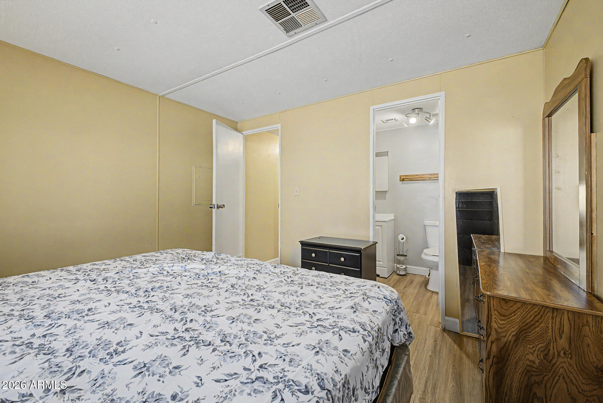 535 South Alma School Road, Unit 40 Mesa, AZ 85210 - Photo 20 of 33 a bedroom with a bed and wooden floor