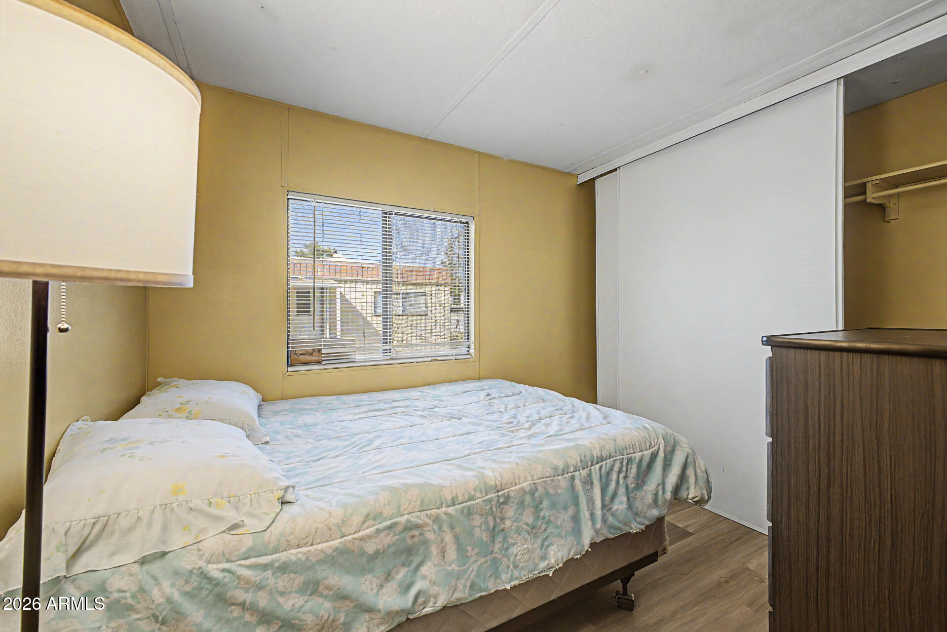 535 South Alma School Road, Unit 40 Mesa, AZ 85210 - Photo 23 of 33 a bedroom with a bed and wooden floor