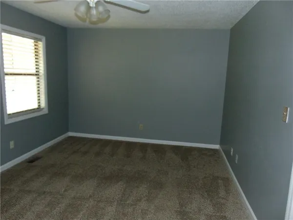 an empty room with a empty space and windows