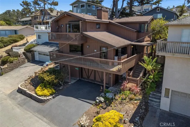an aerial view of a house with swimming pool and ocean view