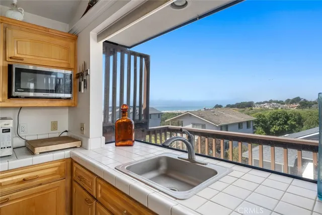 a view of balcony with wooden floor and fence