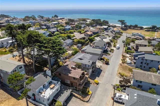 a living room with furniture a fireplace and a chandelier