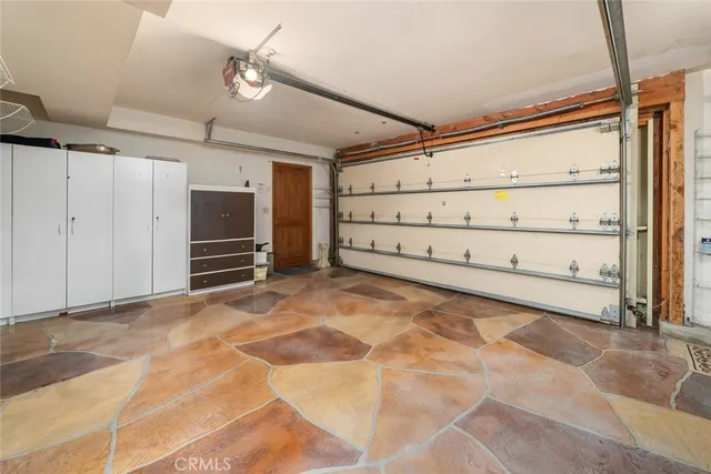 an aerial view of a city with lots of residential buildings and ocean view in back