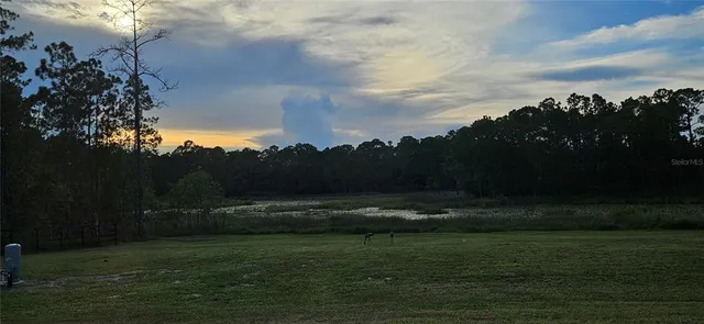 a bathroom with a granite countertop toilet a sink and a mirror